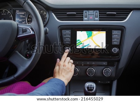Woman using navigation system while driving a car Royalty-Free Stock Photo #216455029