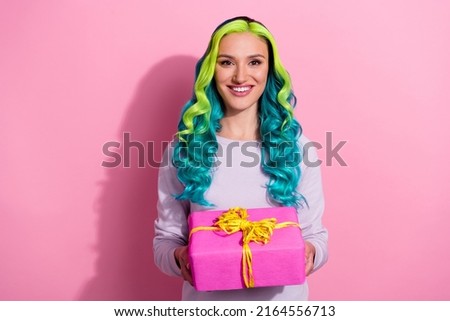 Photo of cheerful young lady give you present enjoy birthday party weekend event isolated on pink color background