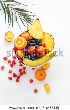 Tropical fruits on a white background top view.