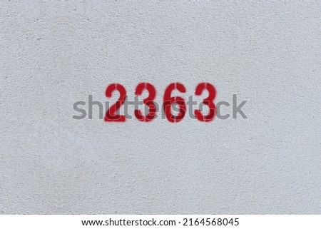 Red Number 2363 on the white wall. Spray paint.
