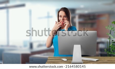 Young woman working at home with laptop and papers on desk