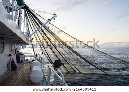 Fishing boat fishing for tuna fish during sunrise. Fishing operation Royalty-Free Stock Photo #2164583411