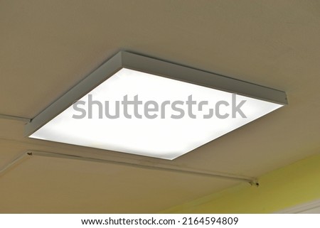 Square white lamp on the ceiling in the office Royalty-Free Stock Photo #2164594809