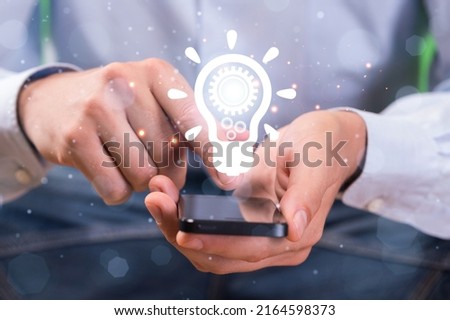 Creative photo concept. Hands with light bulb marketing network icons planning strategy.