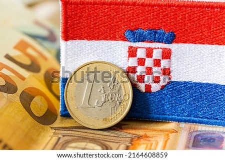 The flag of Croatia against the background of the single currency of the European Union, The concept of Croatia joining the Euro zone Royalty-Free Stock Photo #2164608859