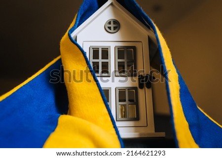 Ukrainian house, embassy in the country with the national yellow-blue flag. Shelter for homeless refugees from Ukraine in Europe affected by the war.
