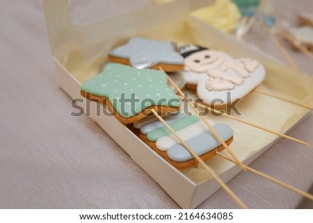 Star shaped gingerbread cookies, cake with baby boy picture. Sweet treats or birthday cake toppeers on wooden skewers