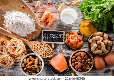 Composition with common food allergens including egg, milk, soya, nuts, fish, seafood, wheat flour, mustard, dried apricots and celery Royalty-Free Stock Photo #2164648345
