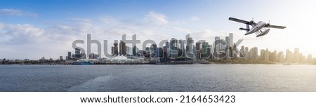 Seaplane flying over Coal Harbour and Canada Place on the West Coast. Adventure Composite. Sunset Sky. Downtown Vancouver, British Columbia, Canada.
