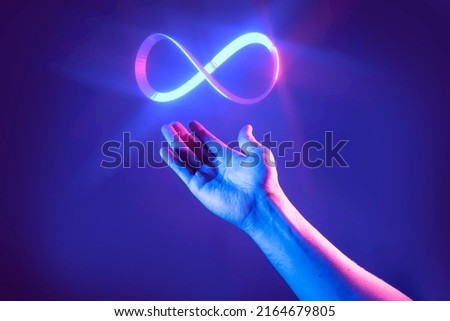 Hand of men pointing on endless infinity sign of virtual reality metaverse digital innovation game or internet online simulation media cyber and world   background Royalty-Free Stock Photo #2164679805