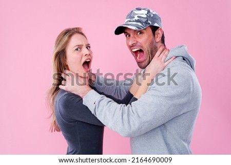 Young couple fighting and screaming at each other, can't resolve an issue and getting into a conflict, man jealous at his girlfriend Royalty-Free Stock Photo #2164690009