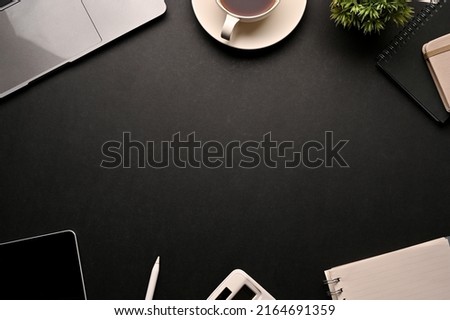 Modern stylish black workspace background surrounded by office objects and copy space for display your text or presentation background. top view 
