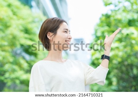 Business woman in a guide pose Royalty-Free Stock Photo #2164710321