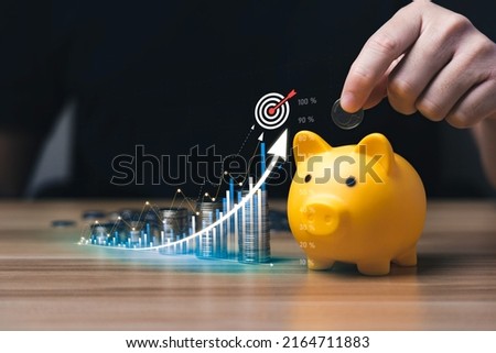 business people save money in piggy bank and goal and achievement chart graph and arrows. Concept Buying Funds Loans and Investment Profits. accumulate assets, wealth, lucrative Royalty-Free Stock Photo #2164711883
