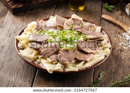 Kazakh national dish beshbarmak with horse meat and boiled dough Royalty-Free Stock Photo #2164727067