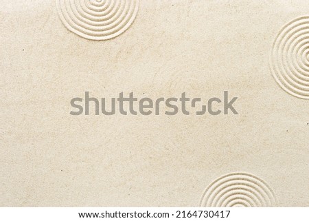Circle lines on sand, beautiful sandy texture. Natural sand background for spa wellness, concept for relaxation balance and harmony spirituality. Concentration and spirituality in Japanese zen garden Royalty-Free Stock Photo #2164730417