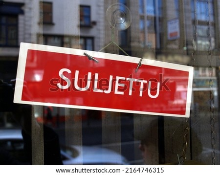 Closed sign in a shop window written in Finnic (translation: Closed)