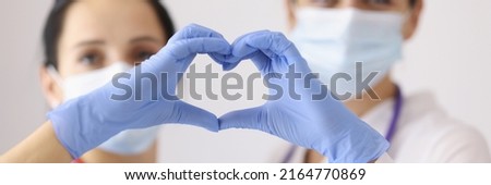 Physicians forming heart with hands Royalty-Free Stock Photo #2164770869