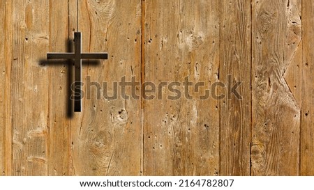 Christian wooden cross on a background of walls