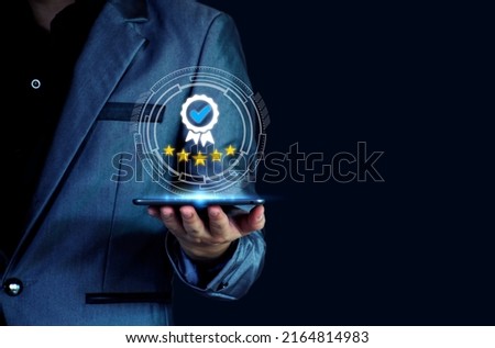 The concept of providing a five-star premium service. businessman showing award High standards are guaranteed, service quality, business success, work efficiency, top quality assurance 5 stars. Royalty-Free Stock Photo #2164814983