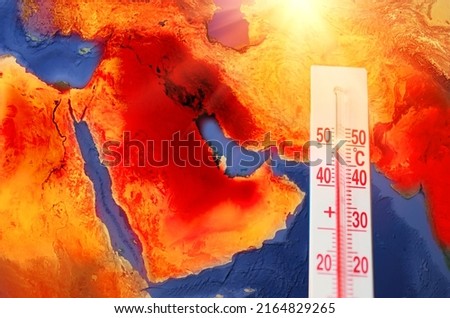 Thermometer with a record high temperature of fifty degrees Celsius, against the backdrop of the Arabian Peninsula, Persian Gulf. Hot weather concept. Elements of this image furnished by NASA Royalty-Free Stock Photo #2164829265