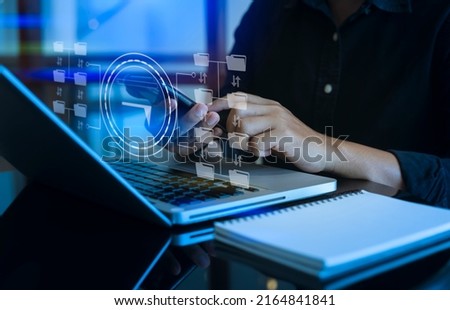 Businessman hands using smartphone with laptop and digital files data interface icons, Business technology and document management online concept.