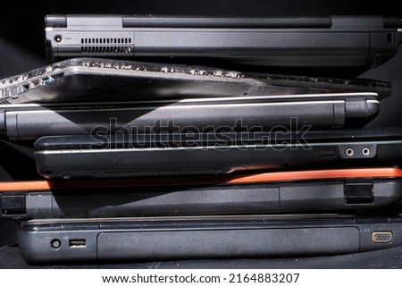 Old used laptop computers for recycling ,Planned obsolescence, e-waste, electronic waste for reuse and recycle concept Stack of old, broken and obsolete laptop computer for repair and recycle Royalty-Free Stock Photo #2164883207