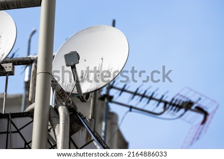 White KU Band Satellite Antenna (Dish) installed on the roof of apartment and high rise in Tokyo to receive TV broadcast Royalty-Free Stock Photo #2164886033