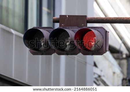 Red Traffic light installed at intersection in downtown Tokyo, Japan to prevent accident and vehicle crash.