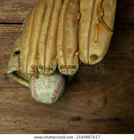 Vintage classic leather baseball glove isolated on wooden background