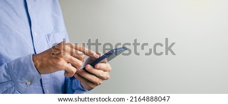 young man with smartphone in hand close-up modern business people shopping online freelance translator at work Search concept or social network Hipster man typing SMS messages to friends