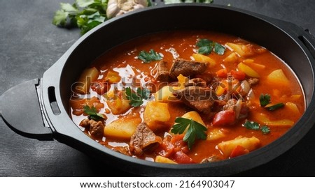 Beef goulash, soup and a stew, made of beef chuck steak, potatoes and plenty of paprika. Hungarian  traditional meal. Royalty-Free Stock Photo #2164903047