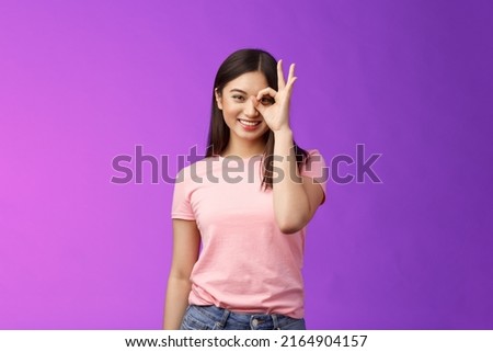 friendly cheerful young asian lady enjoy perfect summer day, show okay ok sign on eye, look through finger-circle, stand purple background joyful, recommend good place, feel excellent