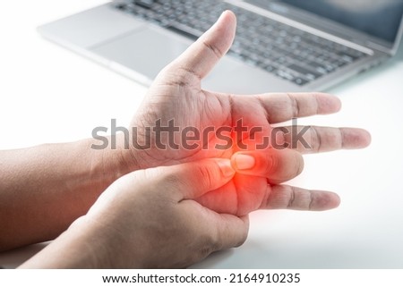 Trigger finger disease, fingers pain from work with computer.Office syndrome concept. Royalty-Free Stock Photo #2164910235