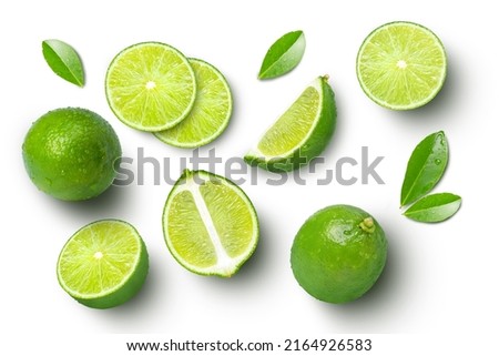 Lime fruits with slices and green leaves isolated on white background. Top view. Flat lay. Royalty-Free Stock Photo #2164926583