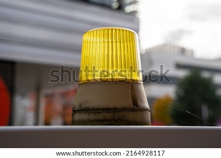 Old yellow signal light on a barrier