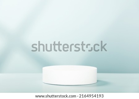 Abstract empty white podium with geometric shadows on blue background. Mock up stand for product presentation. 3D Render. Minimal concept. Advertising template Royalty-Free Stock Photo #2164954193