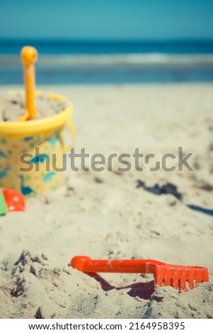 Children plastic toys using for relax and playing on sand at beach. Summer, vacation time and child development