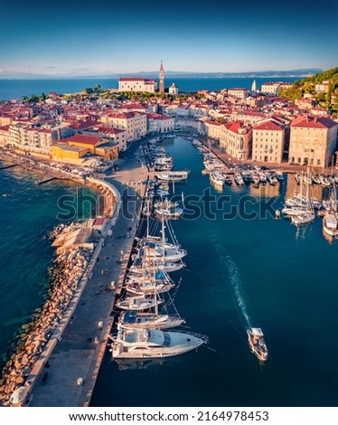Last light glowing Slovenia Adriatic coast with beautiful Venetian architecture. Stunning morning cityscape of Piran town. View from flying drone of old port. Traveling concept background.
 Royalty-Free Stock Photo #2164978453