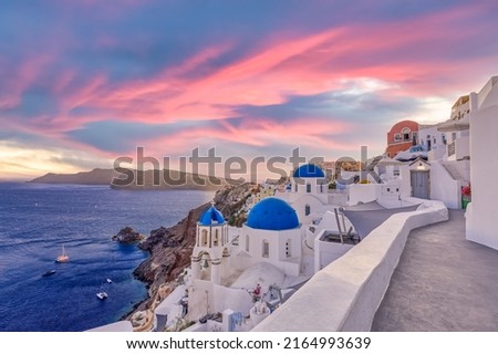 Sunset night view of traditional Greek village Oia on Santorini island in Greece. Santorini is iconic travel destination in Greece, famous sunset point landscape and traditional white architecture