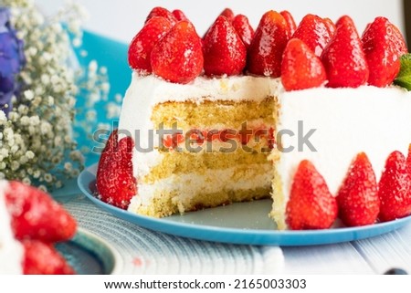 selective focus. Strawberry pie garnished with fresh strawberries. Homemade strawberries cake made from meringue cake and cream with strawberries. Decorated with icing and berries. birthday cake Royalty-Free Stock Photo #2165003303