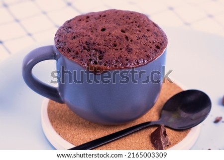 mini cake. Breakfast in a mug. mugcake is microwaved. Homemade cupcake in a mug is on a plate. Chocolate brownie mug cake. Easy cooking concept, microwave baking. muffin chocolate. chocolate biscuit. Royalty-Free Stock Photo #2165003309
