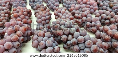 
bunches of grapes on display ready for sale