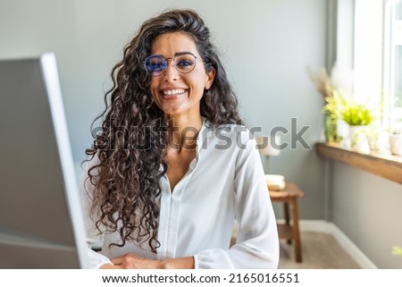 Portrait of businesswoman working in the office. Cropped shot of an attractive young businesswoman working in her office. Successful casual business woman smiling