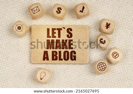 Business concept. On the fabric there are cubes with drawings and a sign with the inscription - Let is Make a Blog