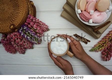 In the hands of a woman, freshly brewed cappuccino coffee