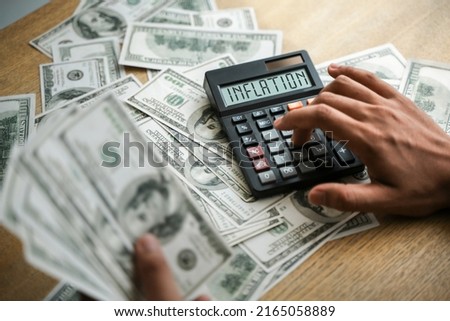 money and calculator mobile money press calculator worsening economy or inflation business concept.