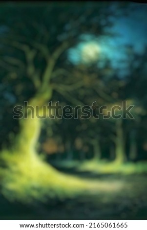 Abstract background texture blur and out of focus moonlight shining on a big tree beside the road