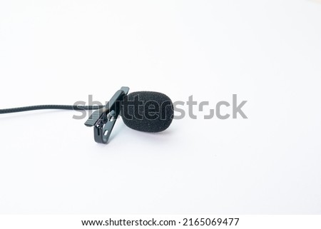 clip on microphone with windshield foam and braided cable isolated on white background