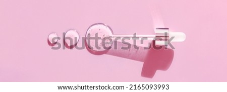 pipette drop of serum test on a pink background	

